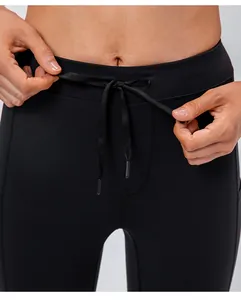 Close-up of high-waisted black yoga pants with adjustable drawstring and matte fabric