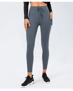 Detail view of high-waist yoga pants with drawstring and functional side pockets