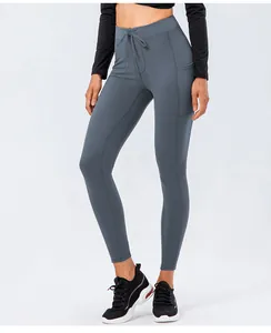 Detail of high-waisted yoga pants with drawstring and side pocket in grey-blue
