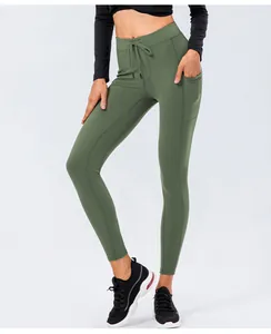 Detail of high-waist olive green yoga leggings with drawstring waist and side pockets