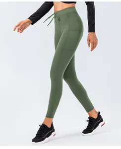 Detail view of olive green yoga pants featuring side pockets and waist drawstring design