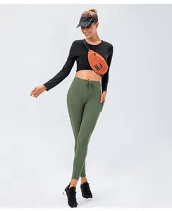 Detail view of high-waist yoga pants with side pockets and adjustable drawstring waist
