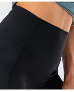 Detail of high waisted yoga shorts showing black elastic fabric and fine double stitching