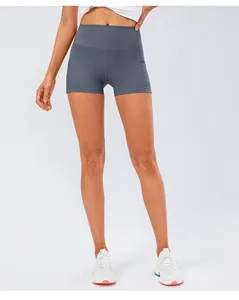Macro view of high-waisted dark grey yoga shorts featuring elastic fabric and wide waistband