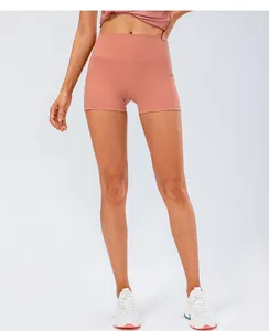 Detail of high-waisted yoga shorts in dusty rose showing elastic tummy control fit