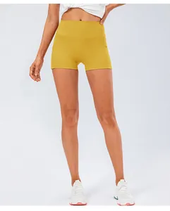 Detail view of high waisted yoga shorts in yellow with functional side pockets