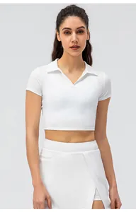 Detalle de top corto blanco con cuello en V y falda a juego en tejido de nailon