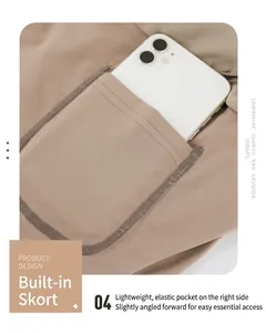 Detail view of khaki sports skirt featuring a stretch inner pocket with a white smartphone