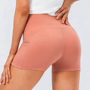 Women's high waisted yoga shorts in coral red with side pockets for fitness running