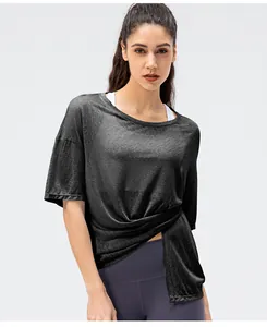 Detail van donkergrijs sneldrogend sport-T-shirt met asymmetrische knoop en split