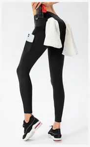 Detail view of high waist yoga pants showing functional towel loop and phone side pocket