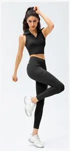 Detail view of high waist black yoga leggings with functional side pockets on model