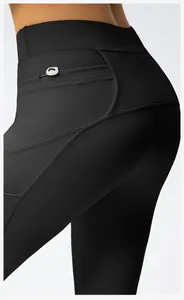 Close-up of high-waist yoga leggings featuring back pocket with round white detail