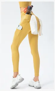 Detail of high waist ginger yoga leggings with side phone pocket and towel holder