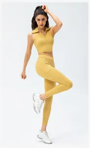 Detail of high-waisted yellow yoga pants with functional side pockets and elastic fabric