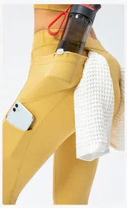 Detail view of ginger yoga pants with functional water bottle pocket and towel loop