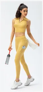 Close-up of yellow high-waisted yoga pants with functional side phone pocket detail