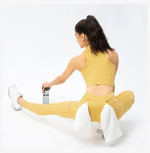 Close-up of functional back waist towel loop on high waist ginger yellow yoga pants