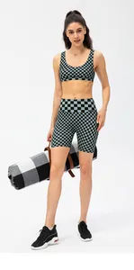 Detail of high-stretch checkered sports bra and biker shorts with sweat-wicking fabric