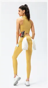 Detail view of ginger yellow sports leggings with phone pockets and towel holder