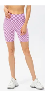 Detail of high-waisted lilac checkerboard sports shorts with compression waistband