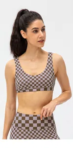 Detailed shot of checkerboard pattern fabric on high-stretch yoga sports bra and leggings