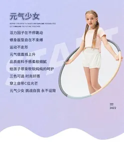 Detail of pink sports t-shirt and white shorts set with a colorful hula hoop