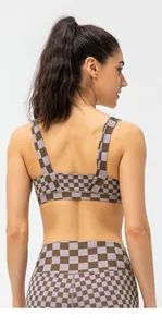 Close-up of cross-back sports bra and high-waist leggings with brown checkered pattern