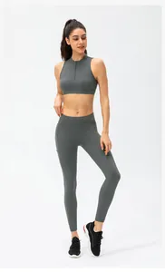 Detail view of high-waist dark grey yoga leggings with side pocket and sleek fit