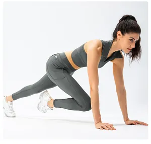 Detail view of charcoal grey high-waisted yoga pants with functional side pockets