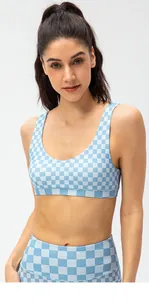 Detail view of checkerboard sports bra and leggings showing the elastic knit fabric texture