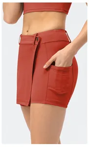 Detail of red-brown skort with side pocket and wrap design for yoga and running
