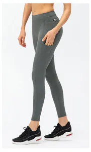 Close-up of high-waisted dark grey yoga pants featuring a practical side pocket and ergonomic seams