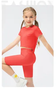 Detail of high-stretch fabric on girls' red athletic crop top and fitted yoga shorts