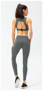 Detail view of high-waist yoga pants featuring back pocket and functional buckle design