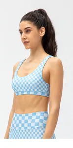 Detail of light blue checkered sports bra and high-waisted leggings set for yoga