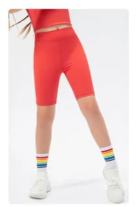 Detail view of red high-waist kids athletic shorts with elastic matte performance fabric