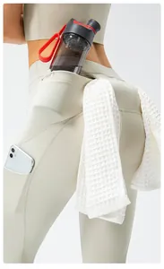 High-waist yoga pants detail showing functional storage for water bottle and towel
