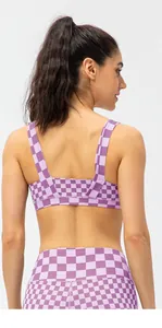 U-shaped back of purple checkerboard sports bra and high-waisted yoga leggings