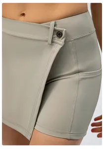 Close-up of asymmetrical yoga skort waist with metallic button and reinforced stitching