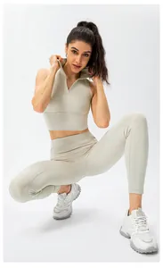 Detail of high-waist cream yoga pants and sleeveless top set for fitness training