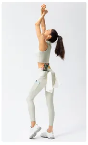 Detail of high waist yoga leggings with side pockets and a functional towel hanger loop