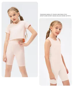 Close-up of girls high-stretch peach pink athletic shorts and matching crop top set