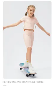 Detail of girl's breathable pink sports set with short sleeves and high elastic shorts