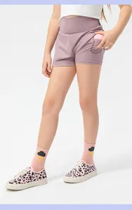 Detail of girls high-waisted pink sports shorts with a functional side tennis ball pocket