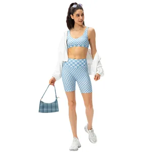 Blue checkerboard sports bra and shorts set with white waffle cardigan for yoga