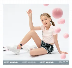 Girl's sportswear set featuring checkered shorts and pink tee with tennis props
