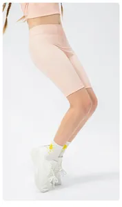 Detail view of pink girls' athletic biker shorts with high waist and breathable fabric