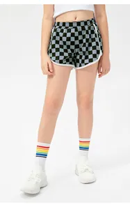 Close-up of girls' checkerboard sports shorts featuring elastic waistband and white trim