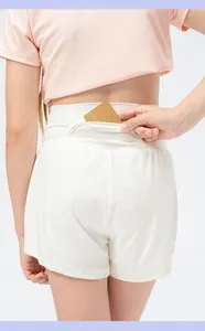 Detail view of functional rear hidden pocket on girls' white quick-dry sports shorts